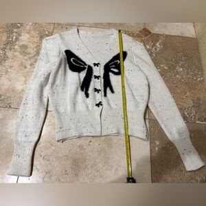 Beige white Cardigan with Black fuzzy Bow Design and cute black bow buttons